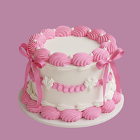 Pink and white cake with decorative ribbons on a pink background