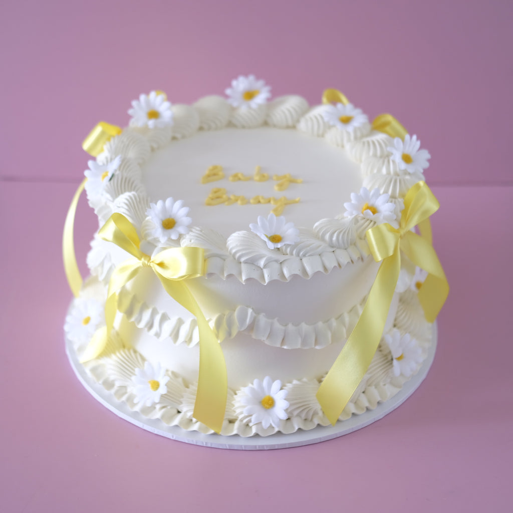 Vintage Round Cake Coquette Daisy - white shell piping with daisy blooms and yellow bows Brisbane